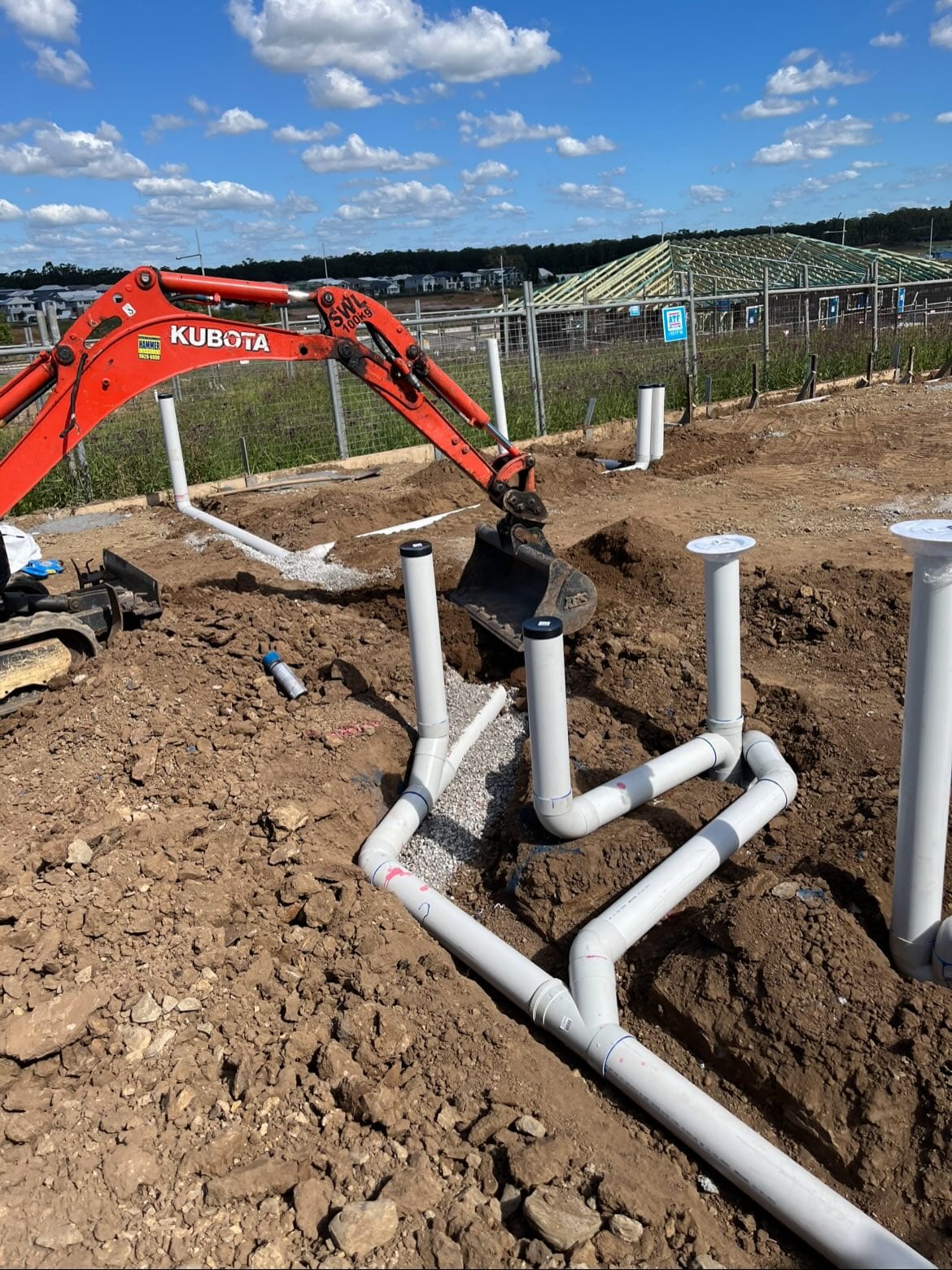 New-build drainage rough-in with graded PVC pipework
